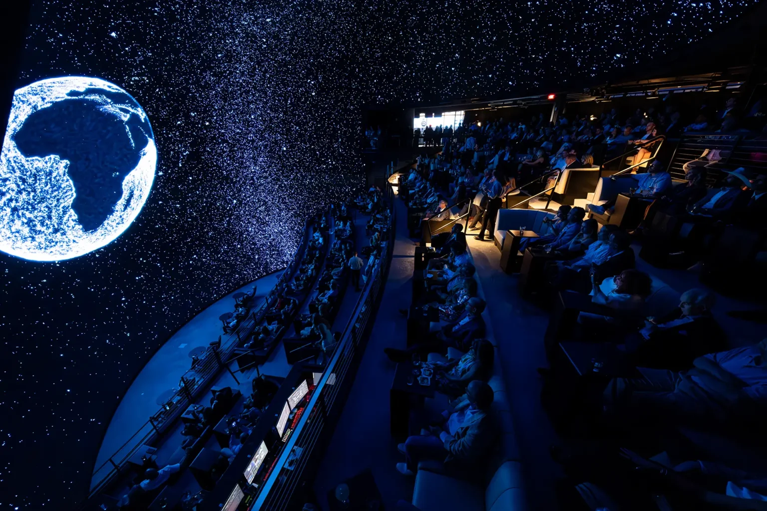 Guests experiencing the immersive LED dome at COSM during a corporate event.