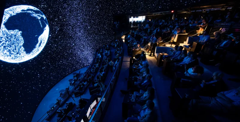 Guests experiencing the immersive LED dome at COSM during a corporate event.
