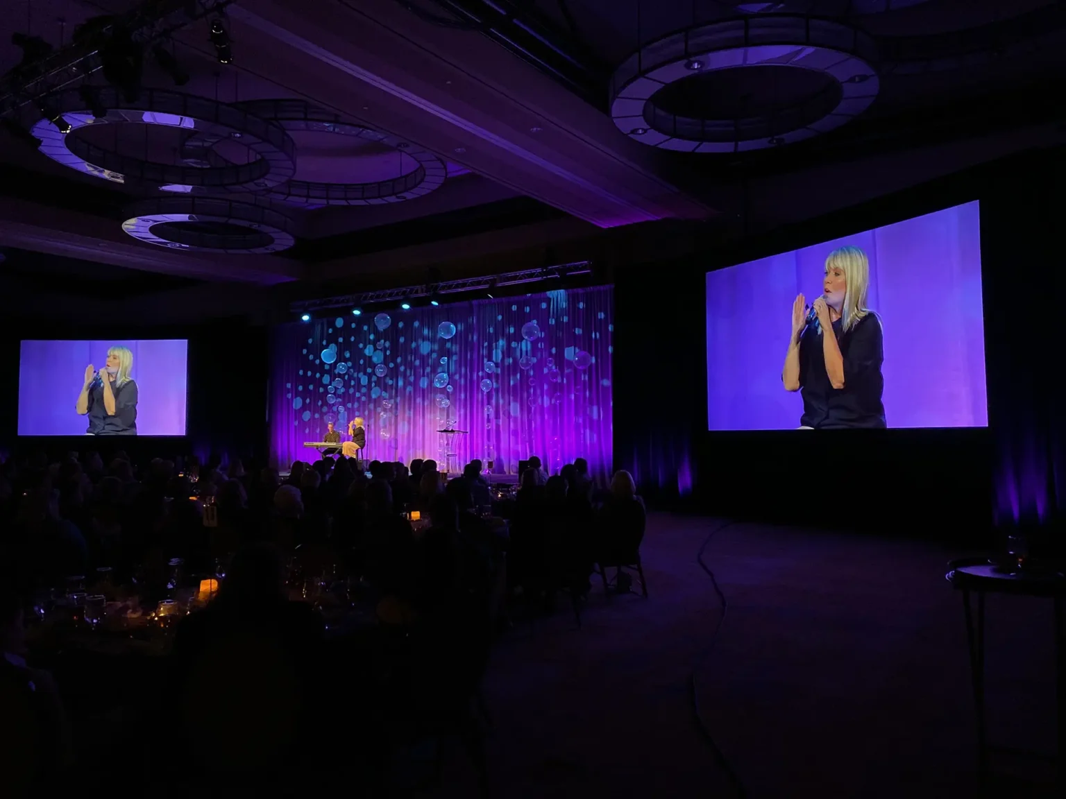 Speaker presenting at a corporate event inside the Nasher Sculpture Center with professional AV production.